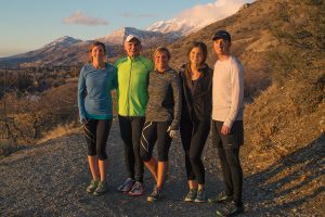 The Harper Family on a trail in the mountains. They are wearing their running gear.