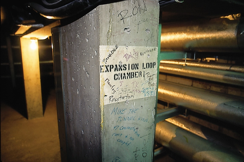 A cement pillar with a sign that reads "Expansion Loop Chamber"