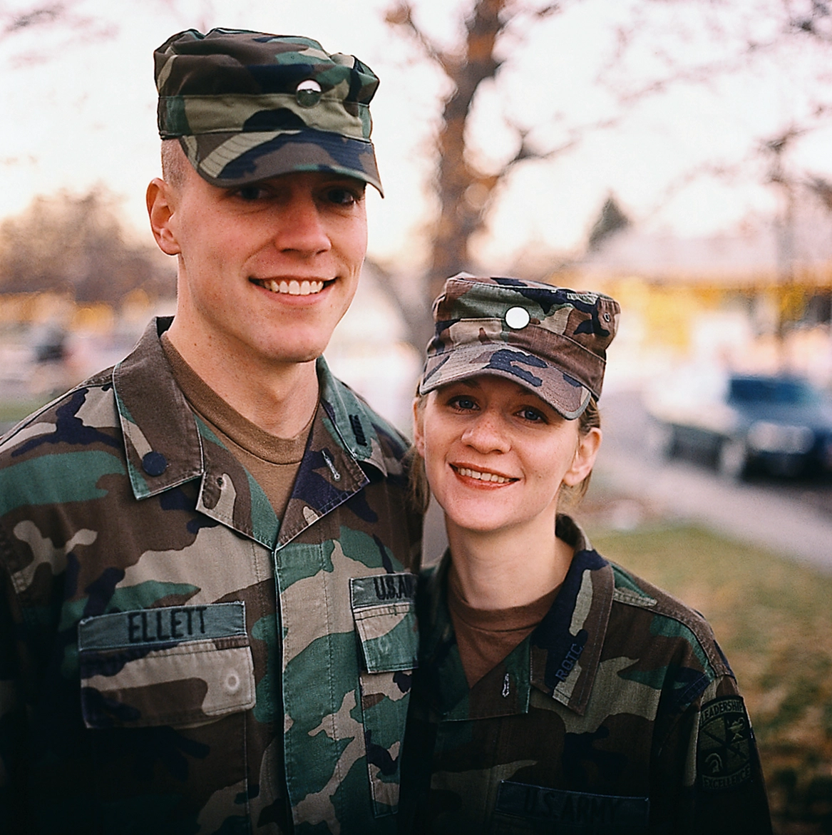 Matt and Mandy stand together in their army uniforms.