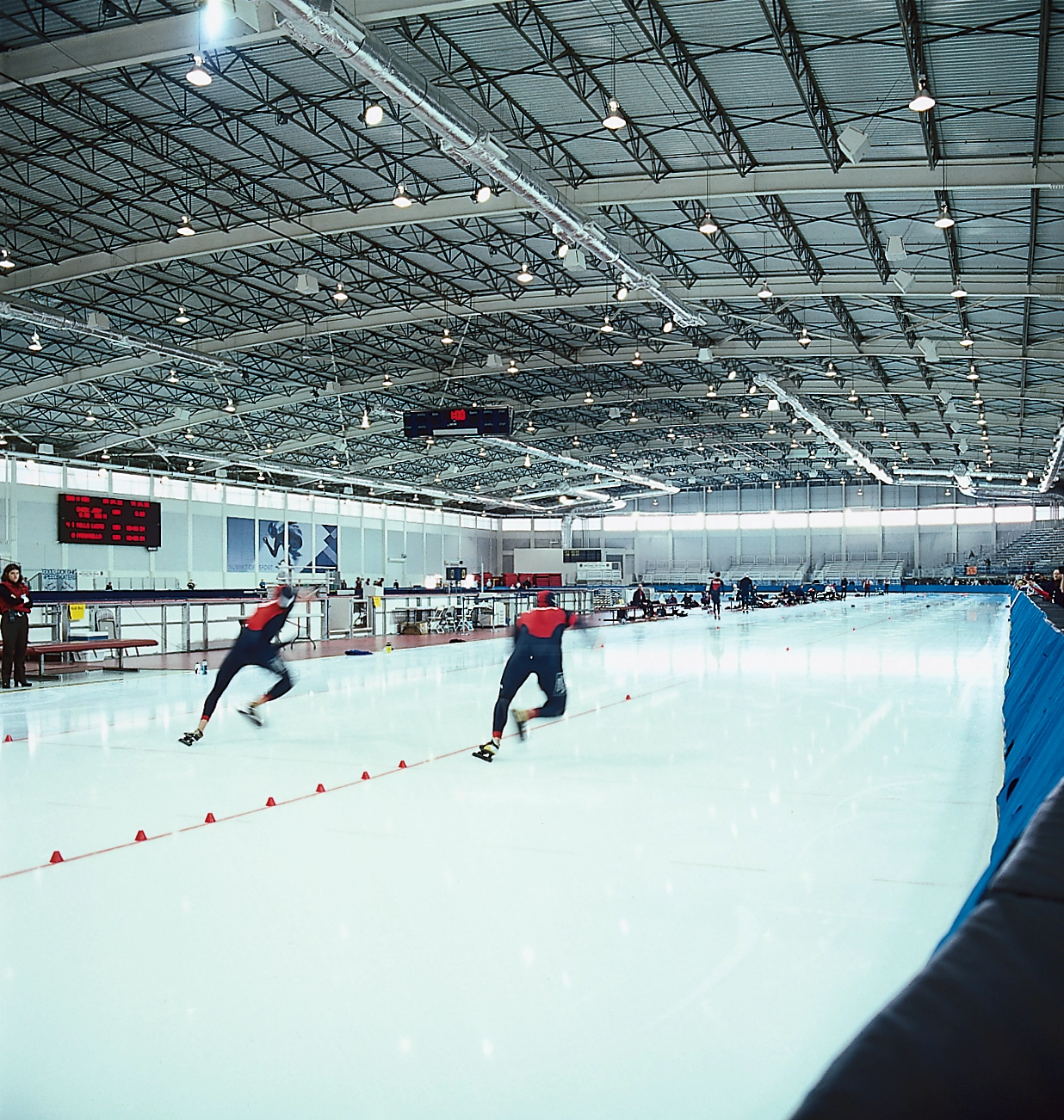 Two ice skaters race down the olympic track for the winter games in Utah.