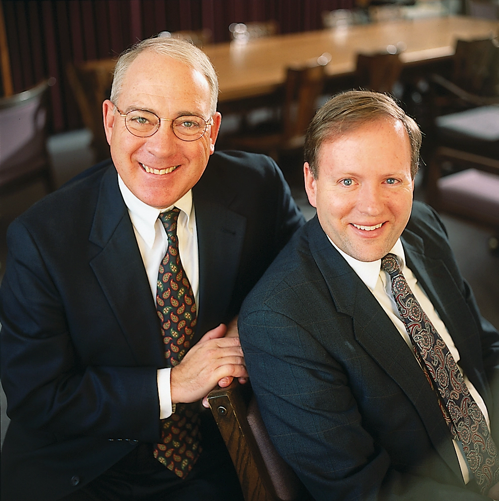 Robert C. Freeman and Dennis A. Wright pose in a conference room.