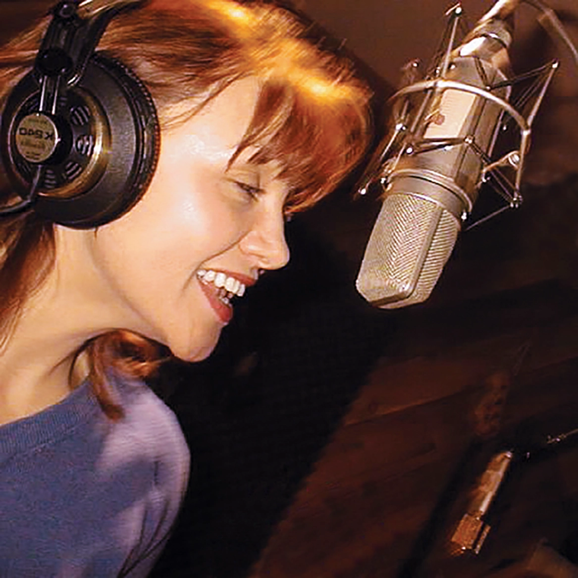 Sheree Fitzgerald singing in a recording studio.