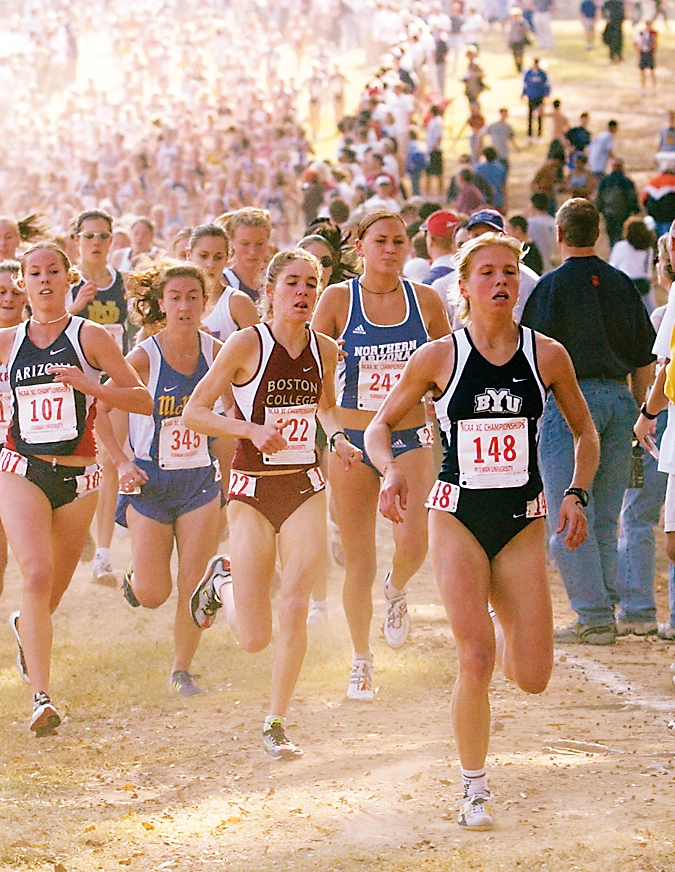 A group of women run down a dirt path.