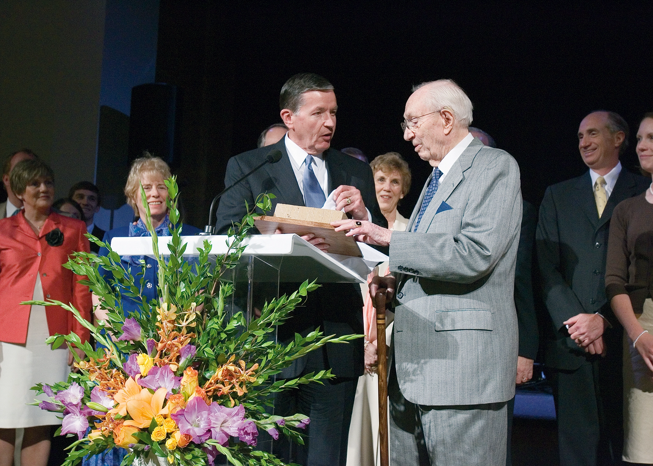 BYU President Samuelson hands a plaque to President Hinckley.