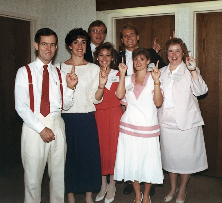 A group of five students stand with their two mentors.