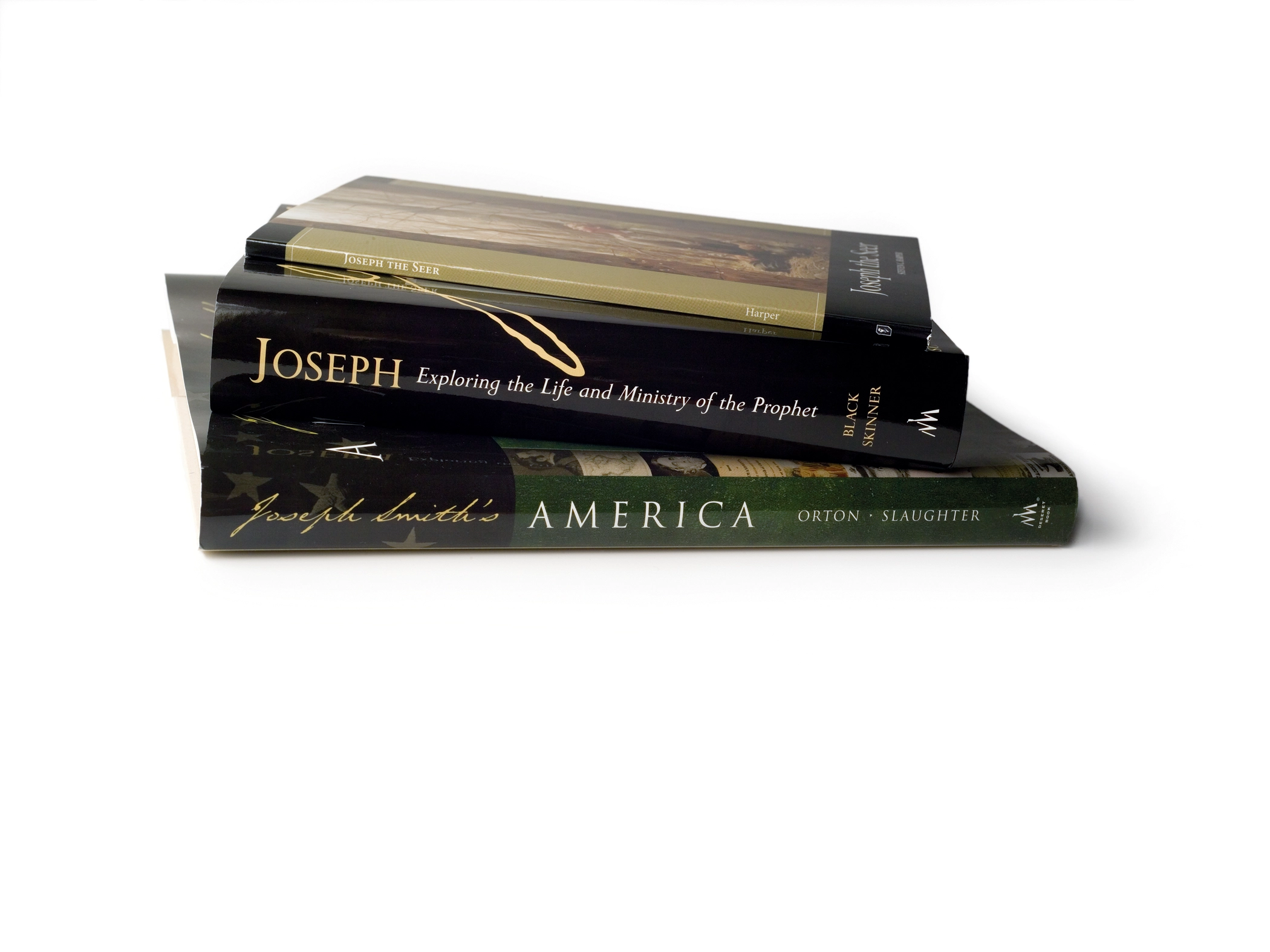 A stack of books with the spines reading "Joseph Smith's America," Joseph: Exploring the Life and Mister of the Prophet," and "Joseph the Seer."