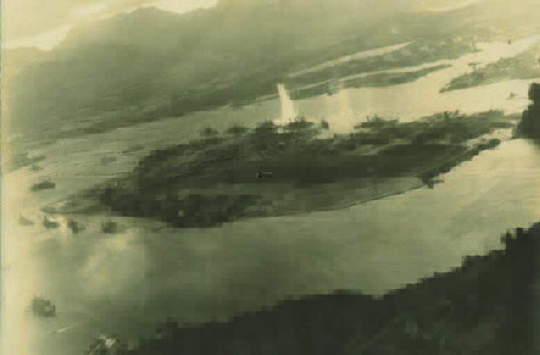 An archival aerial photo of Pearl Harbor being bombed on December 7, 1941