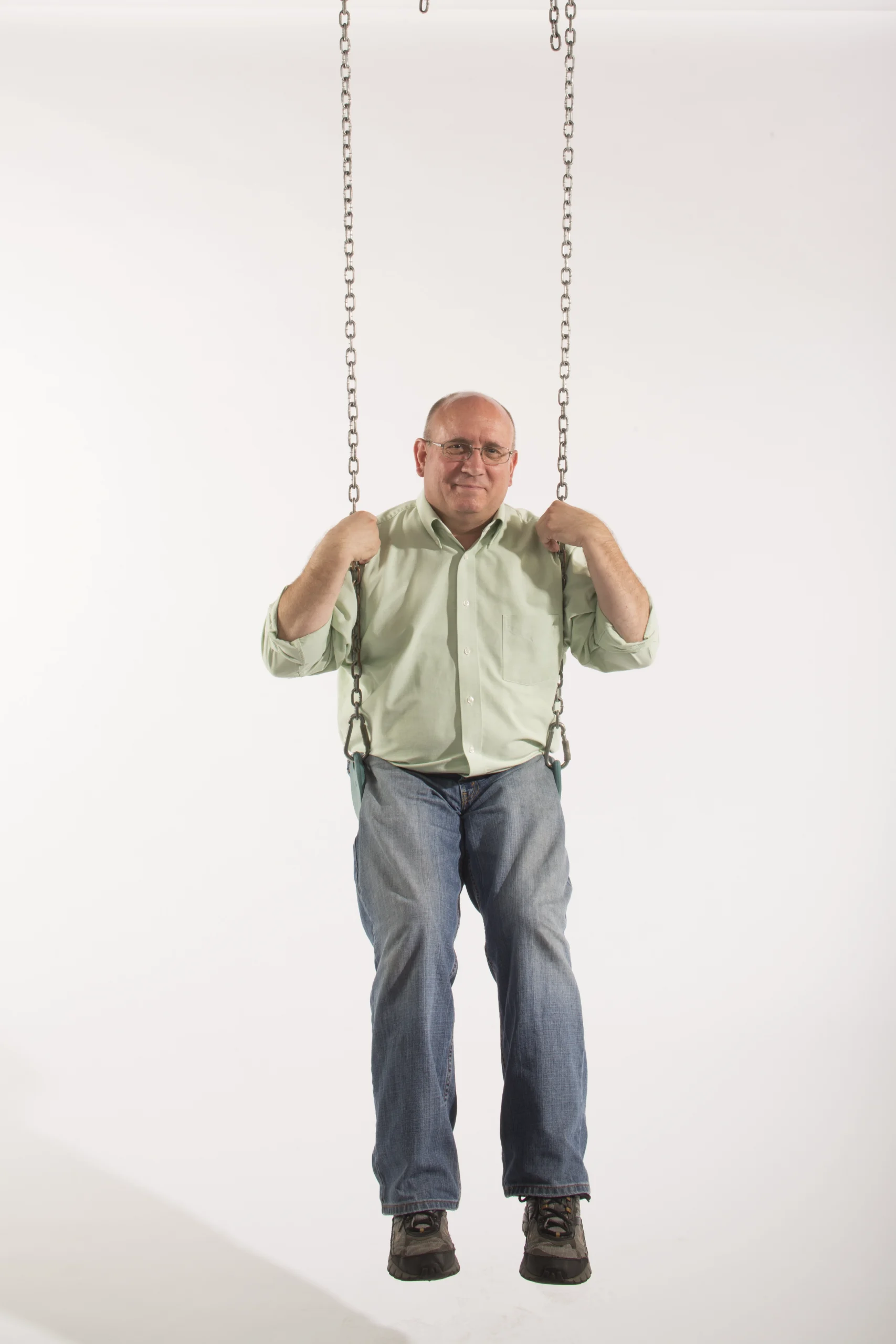 Morrison sitting in a swing.