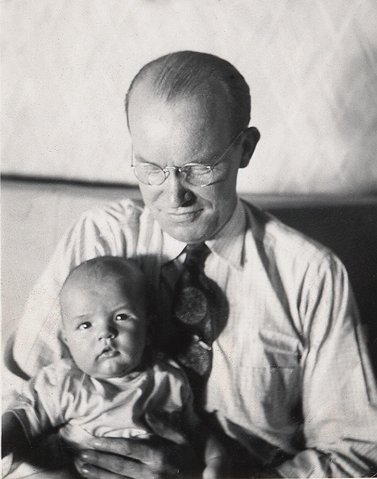 Cecil O. Samuelson as a baby being held by his father.