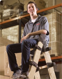 Spencer Quinn perches on a ladder crafted with his wonder tape.