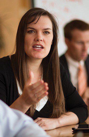 A woman speaking and motioning with her hand.