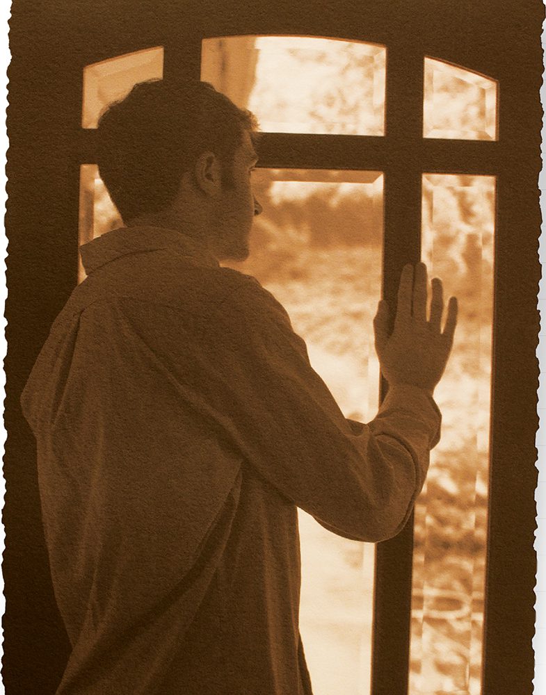 Young person looking out a window.