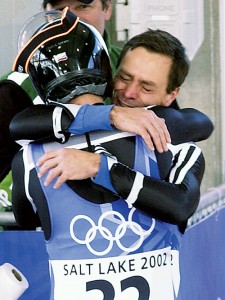 Werner Hoeger shares an emotional moment with his son Christopher after both completed their best luge runs ever. 