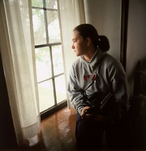 Lori C. Newbold, '05, sits near a window in Carthage Jail. During the course of the semester, students go on field studies to other sites in Illinois and to New York, Ohio, Missouri, and Iowa.