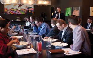 Chris Feinauer (BS '80), sales manager for U.S. Bank's northwest region, speaks to recent graduates at a networking luncheon. 