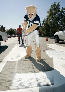 Cosmo lends a painting paw to Provo City workers, adding a white block Y at the intersection of University Avenue and Center Street. This and other Cougar Town efforts has encouraged community support beyond the borders of Provo proper. 