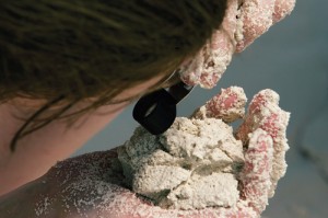 Student observing the hardened ooid sand.