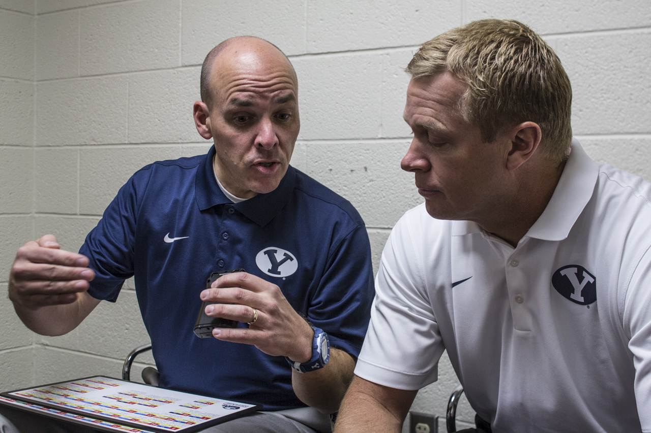 Wrubells sits next to Bronco Mendenhall as they discuss the game