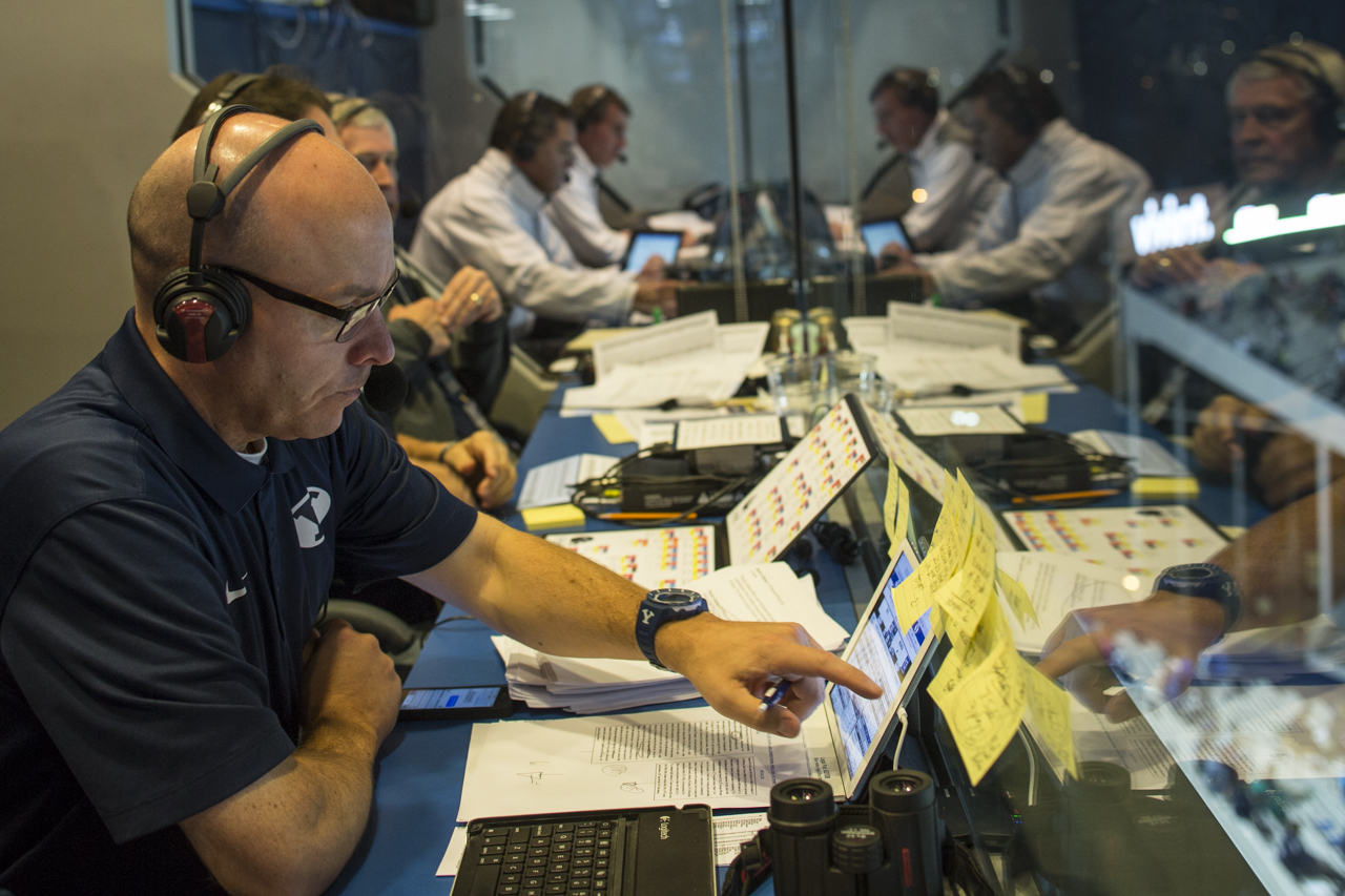 Wrubell sits in the football press box preparing for a game by reading over his notes