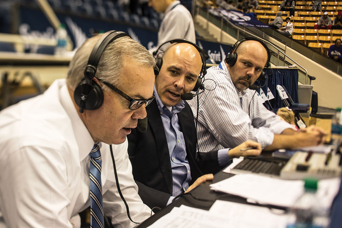 Wrubell and his radio partners speak on air after a basketball game