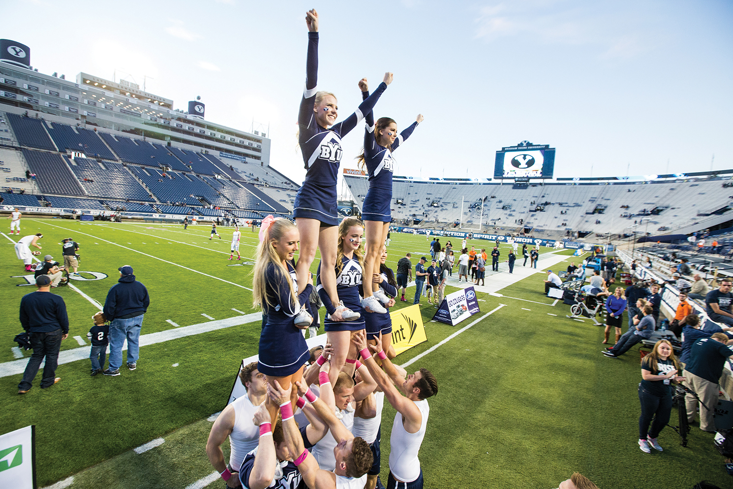 BYU cheerleaders entertain fans by forming a pyramid.