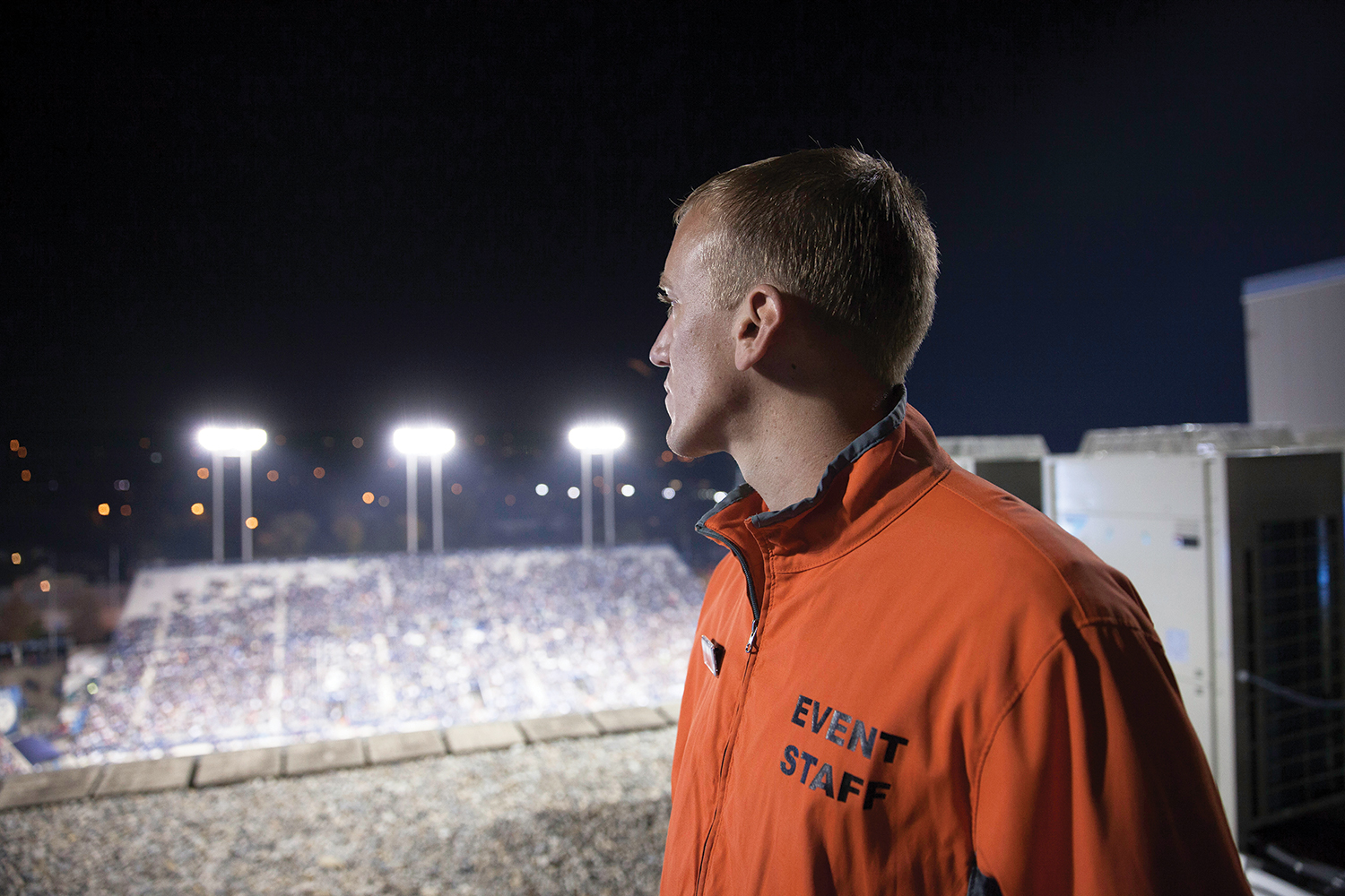 A student security worker watches the field from the stadium roof.