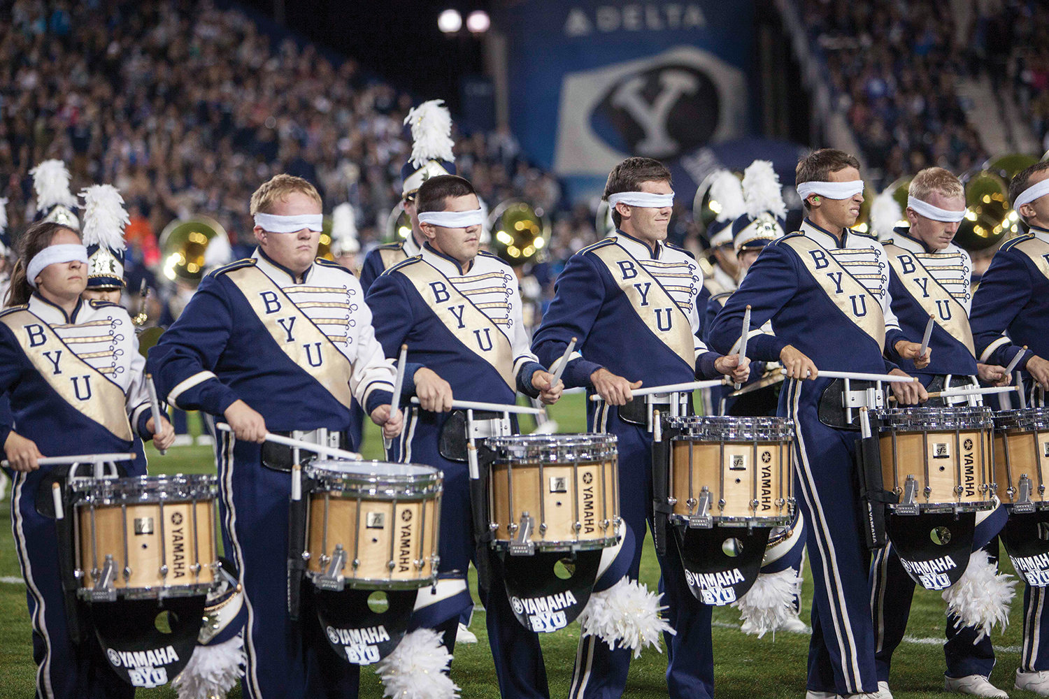 The drum line of the BYU Marching Band performs a tough sequence blindfolded.