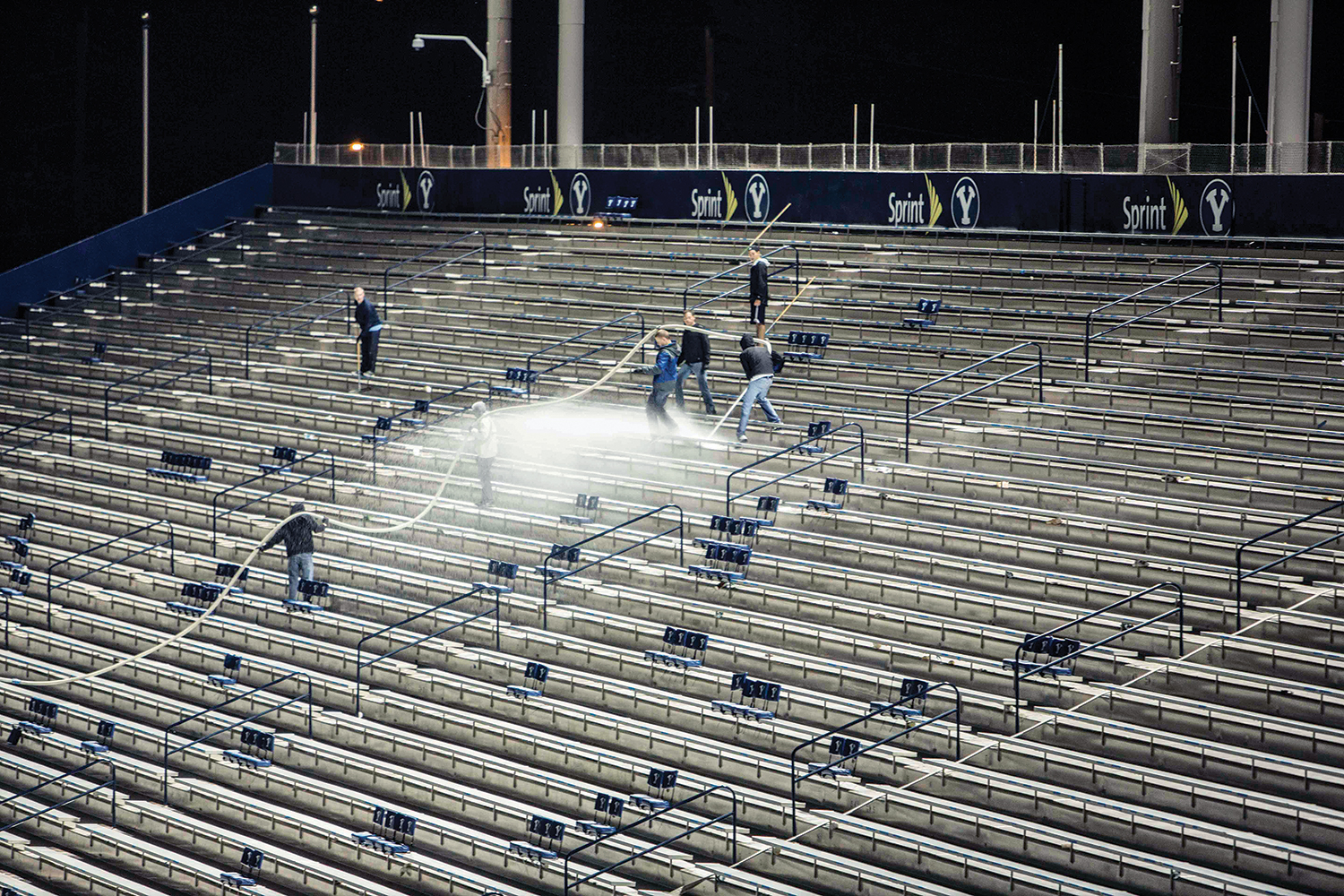Teams of volunteers hose down the bleachers after a game.