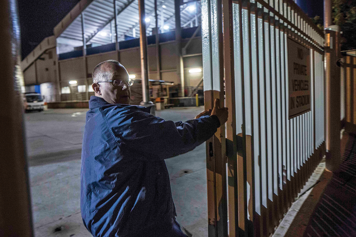 An event supervisor shuts the gates to BYU's LaVell Edwards Stadium at 3:24 a.m., the last man out after a long day.