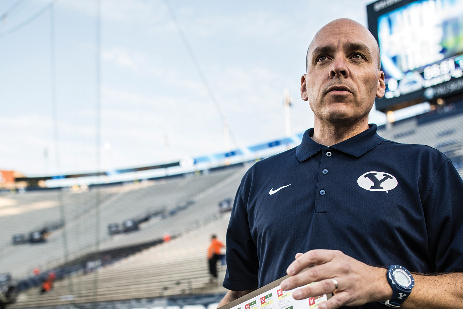 Greg Wrubell looks over the field before a football game with a serious look on his face