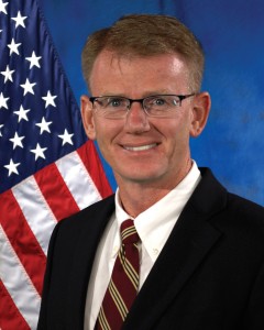 Portrait of Bradley Hansen with the American Flag in the background.