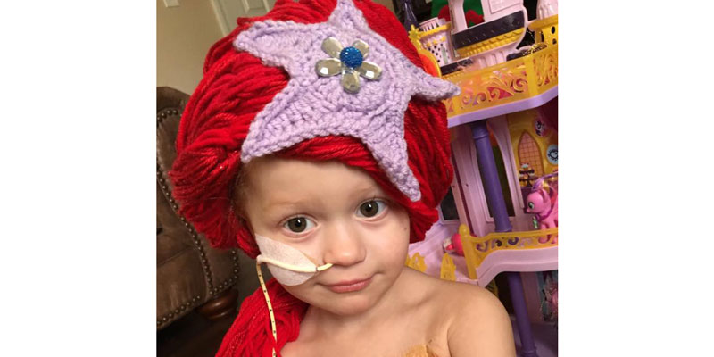 Young cancer patient wearing a princess wig.
