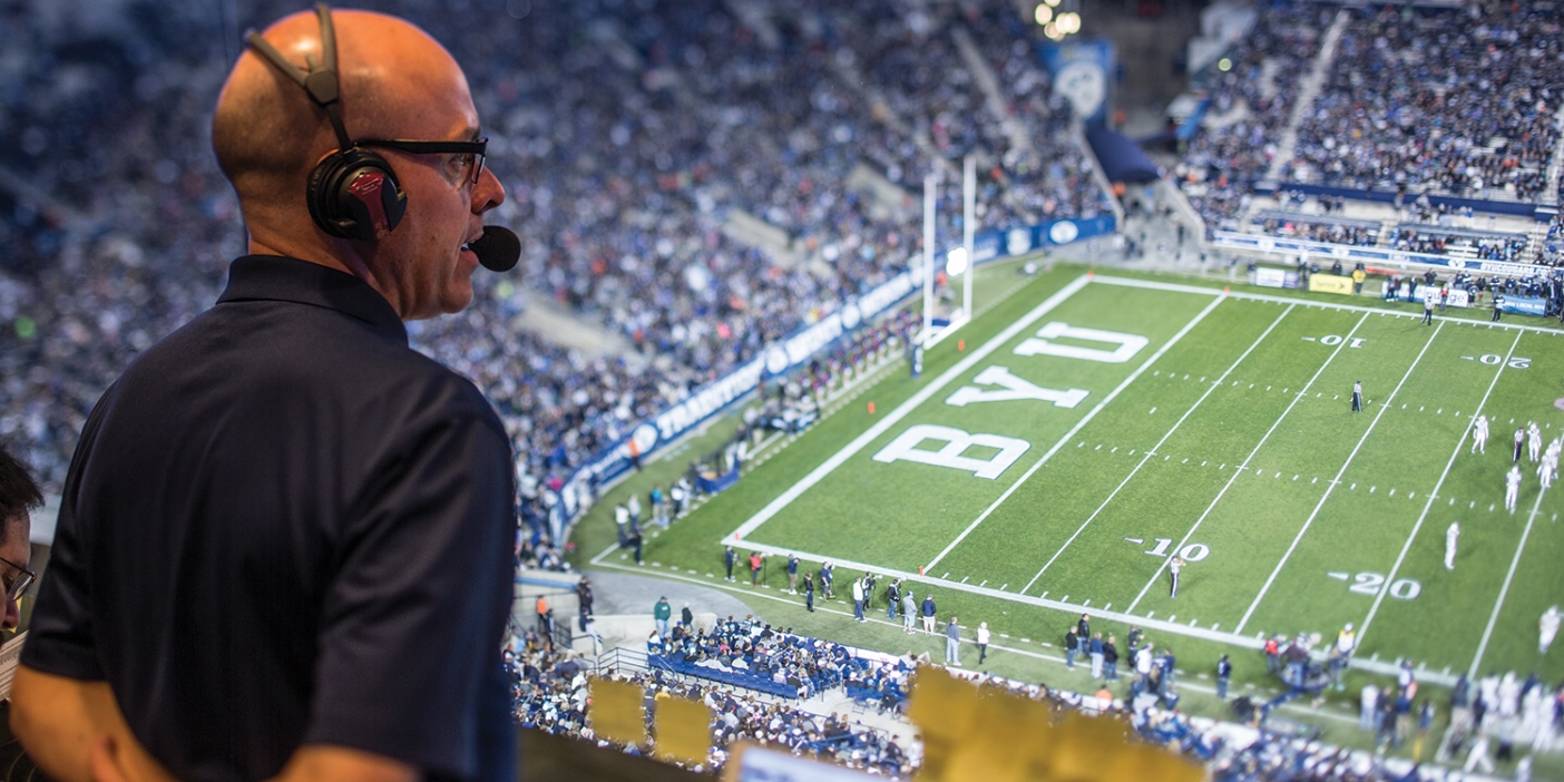 Greg Wrubell looks out from his box at a BYU football game