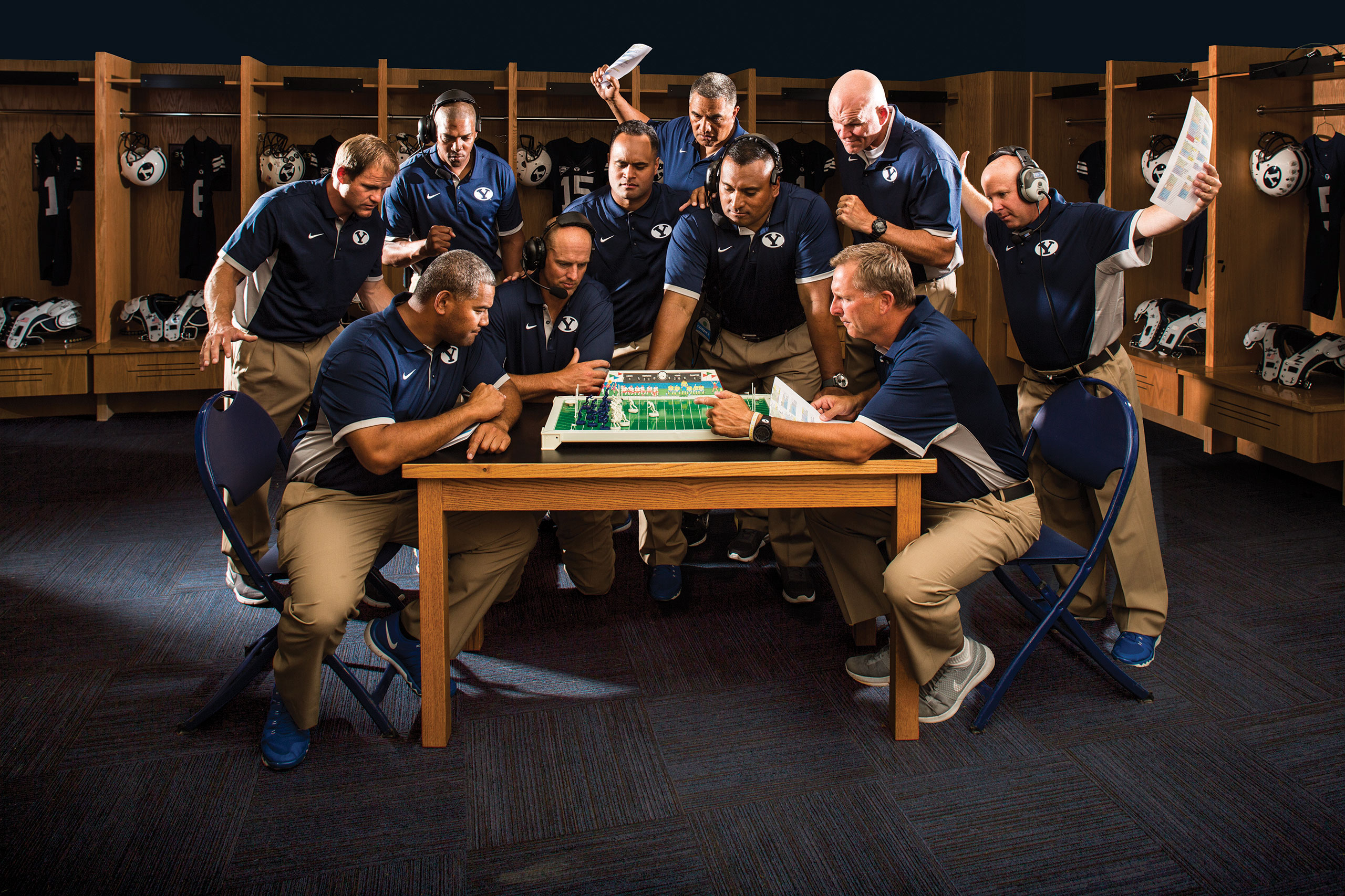 football coaches huddled around a table