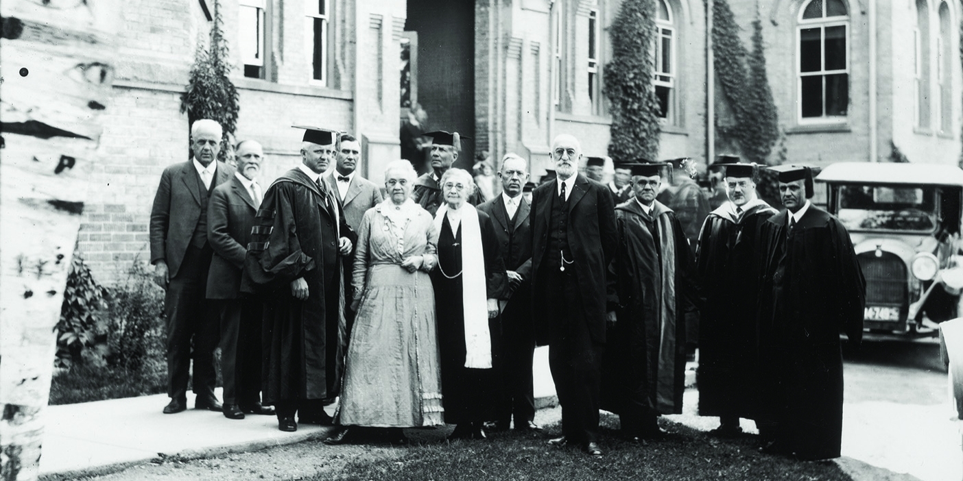 Susa Young Gates is pictured with President Heber J. Grant and other members of the BYU Board of Trustees at a 1920s commencement