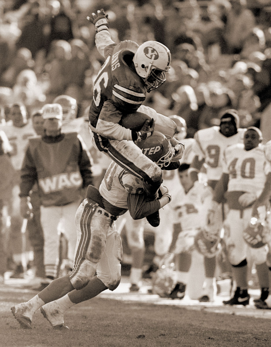 Chad Lewis leaps over a defender in a 1993 football game.