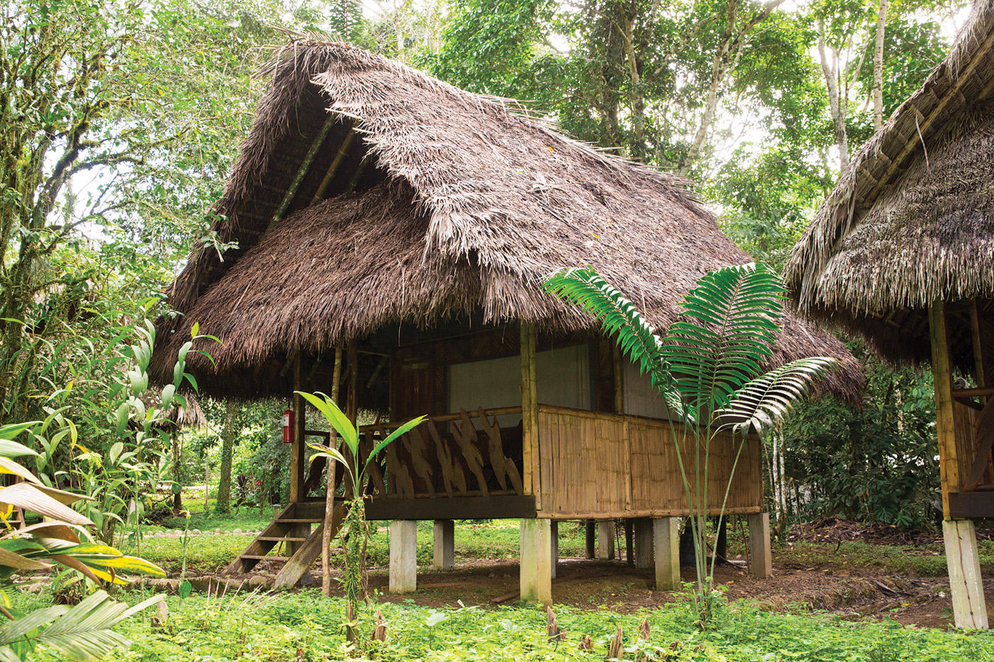 A thatched-roof hut on stilts that is part of the school compound