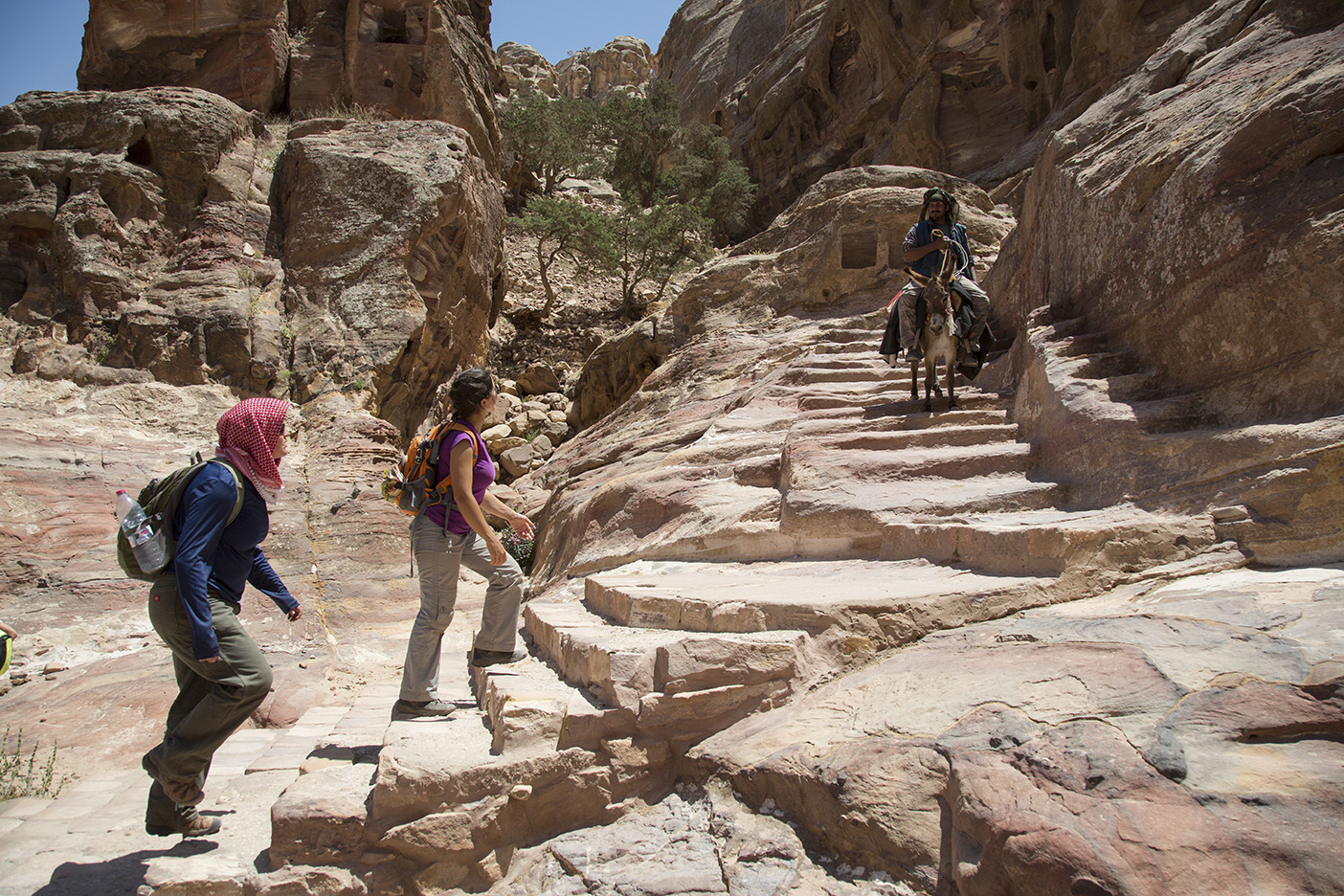 Students scale 800 stone steps leading to the Ad-Deir Monument.