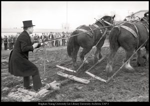 Dressed in 19th-century costume, President Dallin H. Oaks (BS ’54) rides a scraper behind a team of Clydesdales, helping break ground for the Centennial Carillon Tower on Feb. 13, 1975.