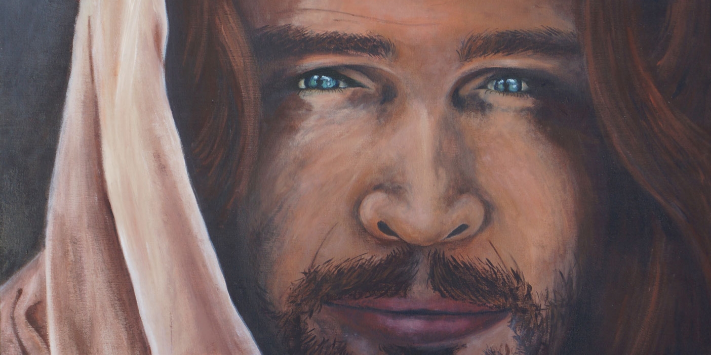 Painting of Jesus Christ's face with piercing blue eyes.