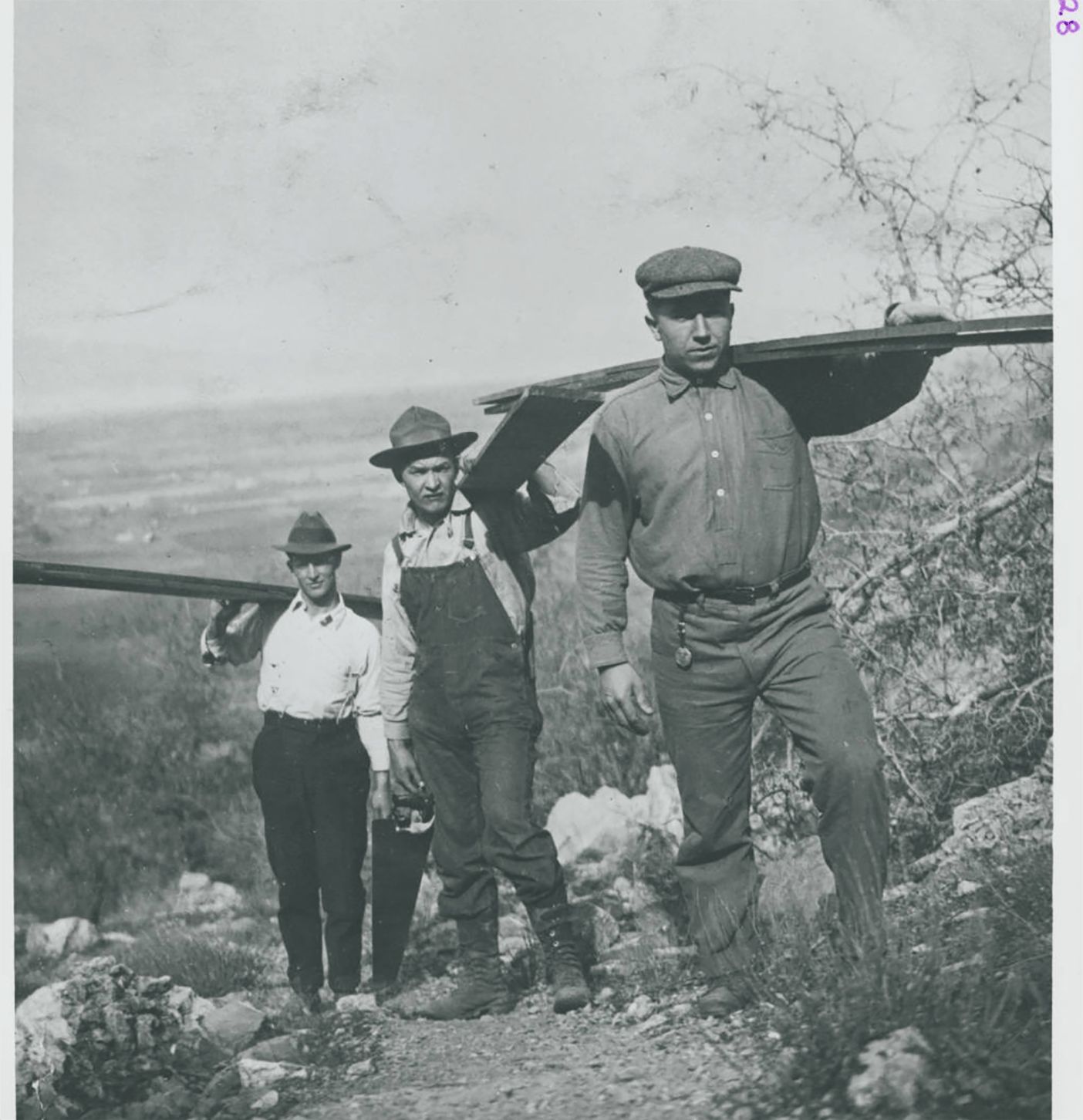 Workers carrying boards up the mountainside in 1915.