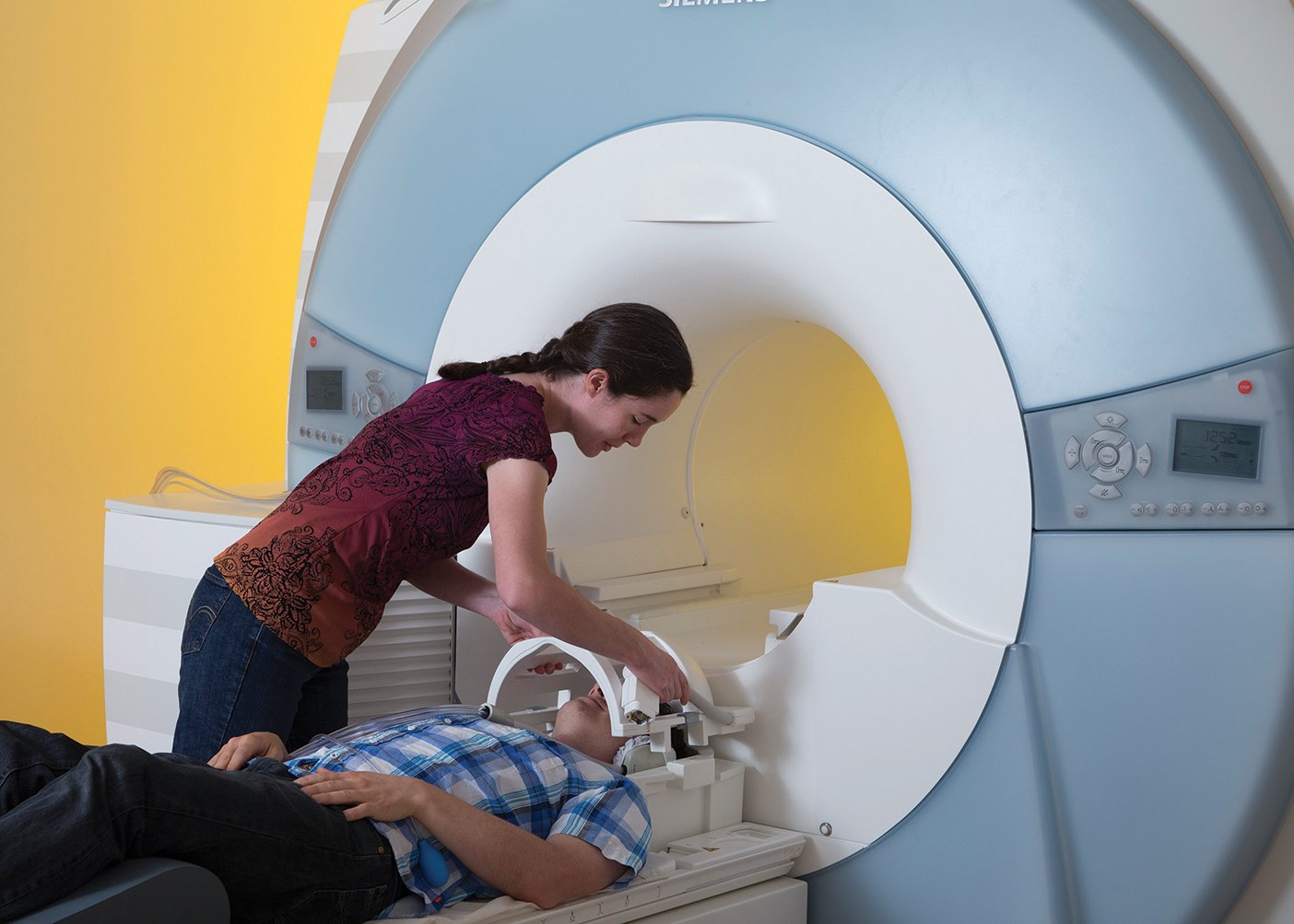 A person being prepared to go into an MRI machine
