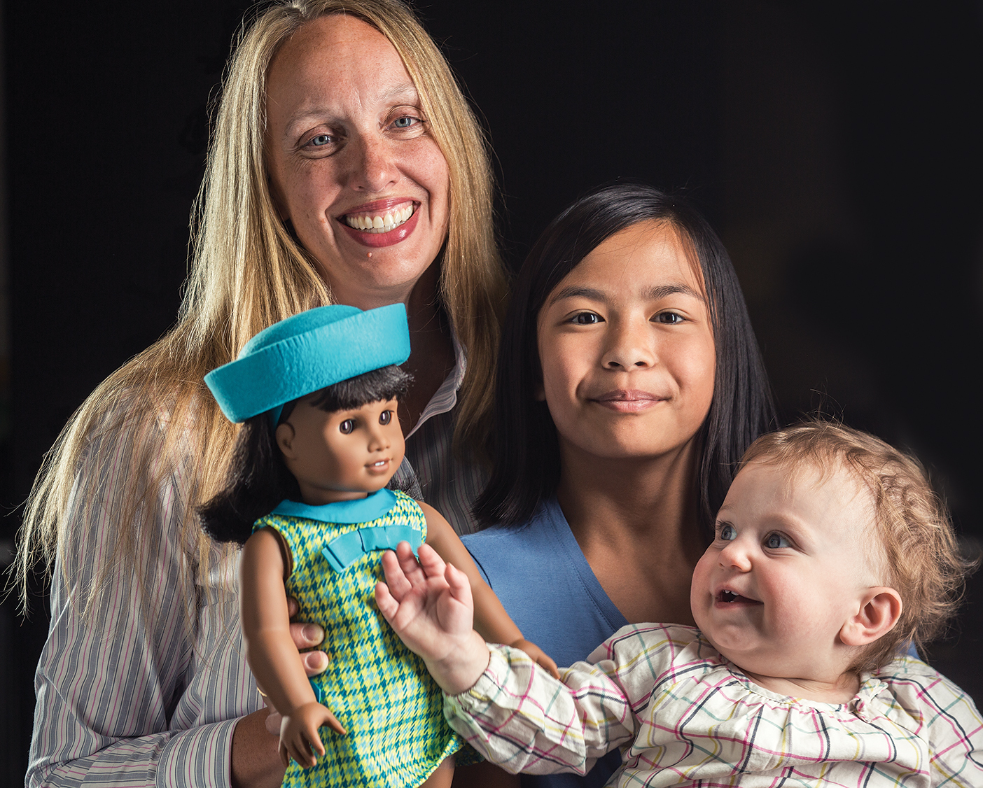 Rebecca Christensen de Schweinitz with her children and the newly released American Girl Doll Melody.