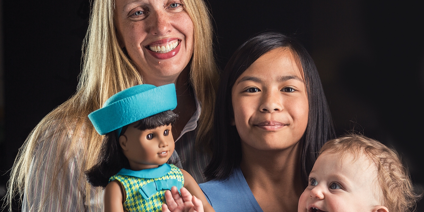 Rebecca Christensen de Schweinitz with her children and the newly released American Girl Doll Melody.