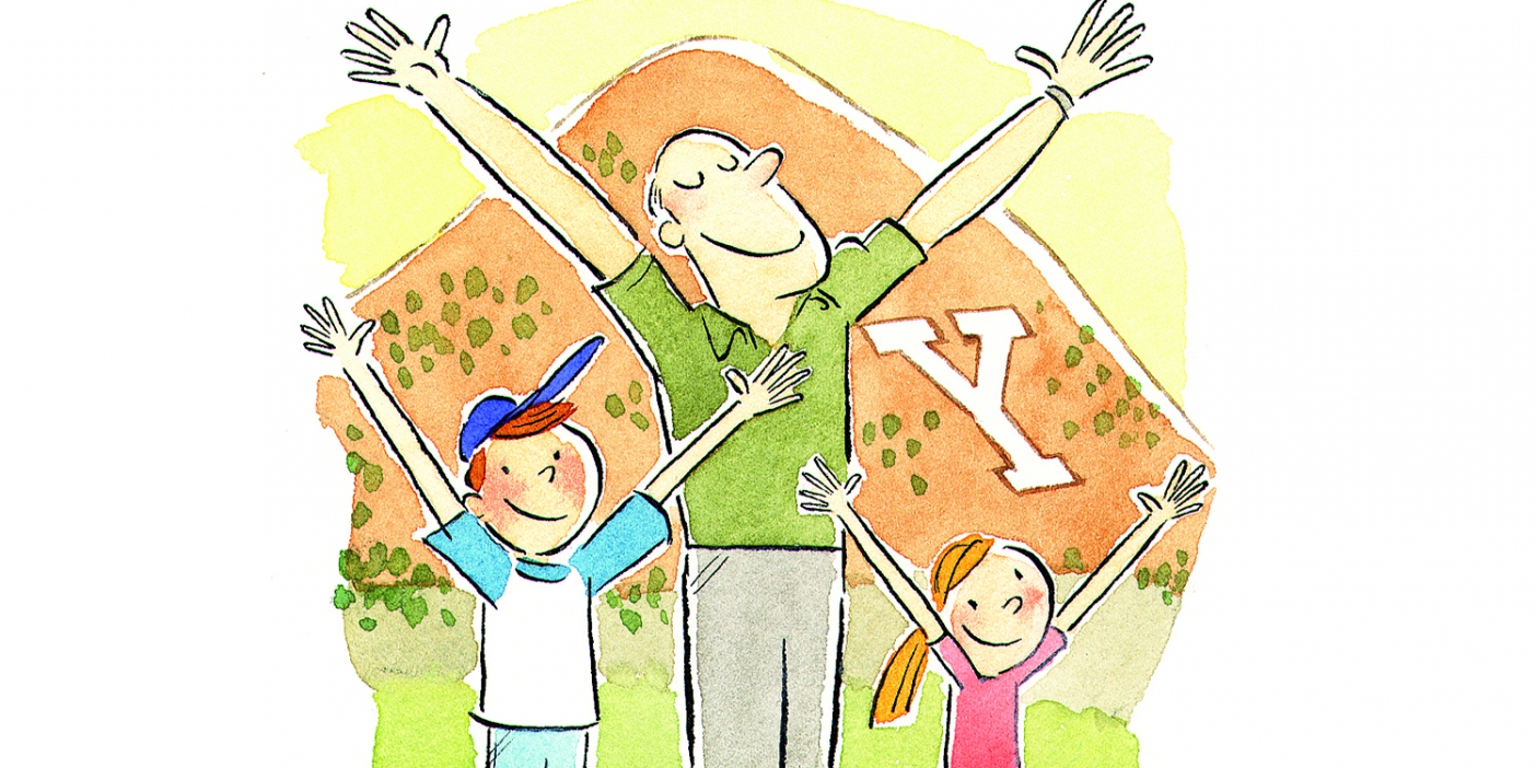 A father and two kids hold their arms in the Y shape in front of Y Mountain