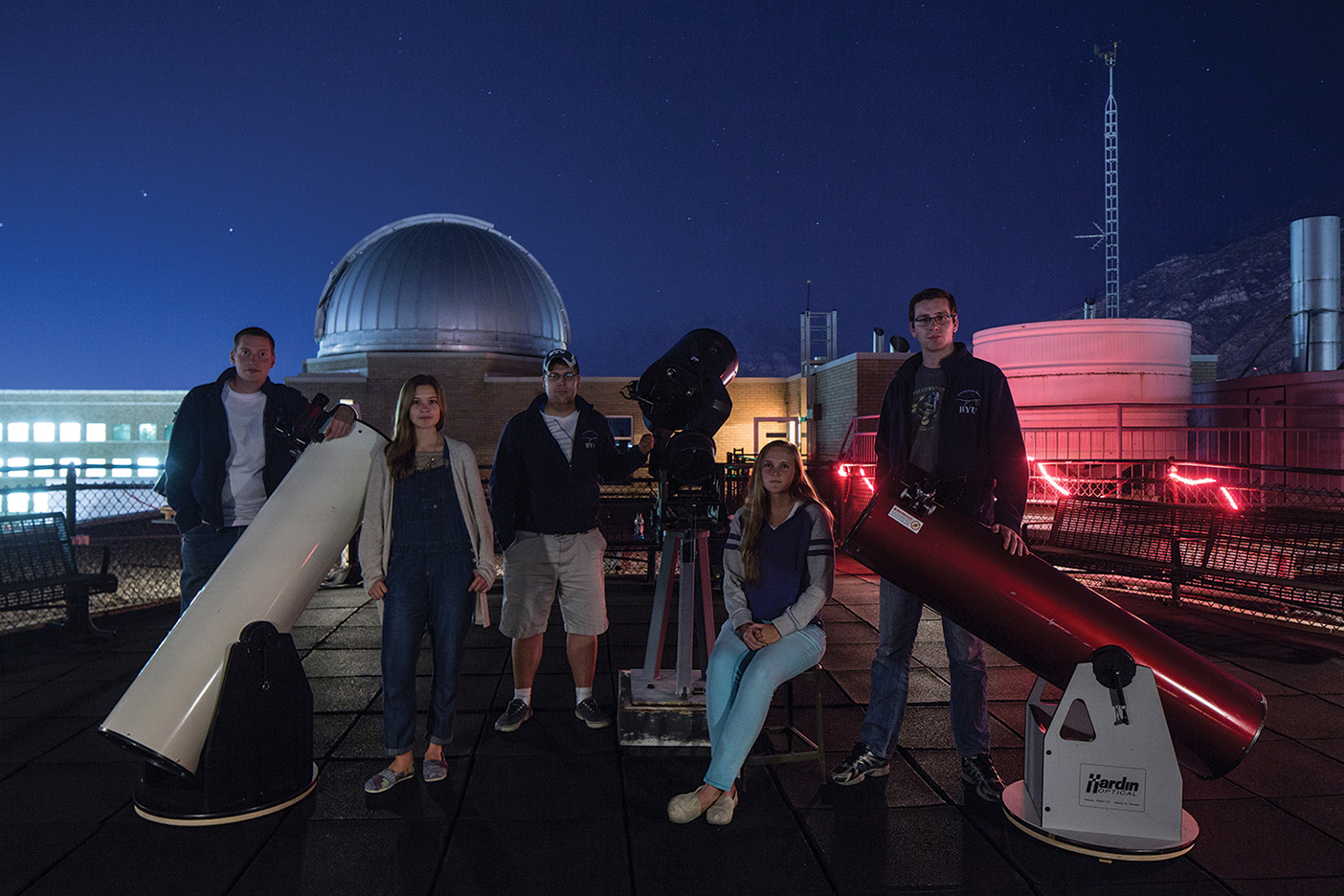 Students from the Astronomy Club sit in front of the Eyring Center Observatory.