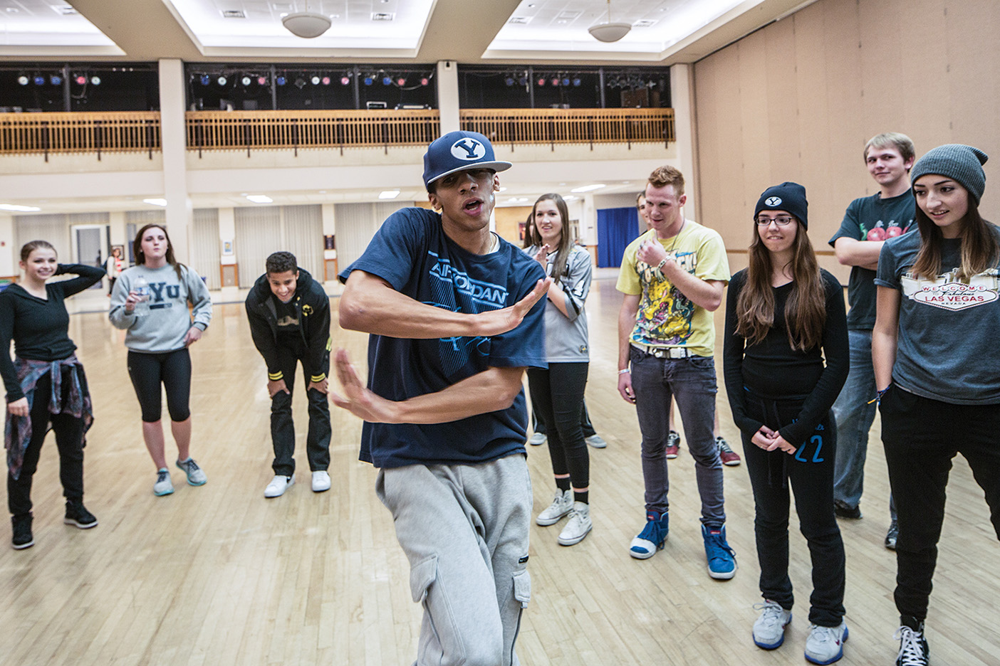 A student Hip-Hop dancing with his arms parallell across the front of his chest.