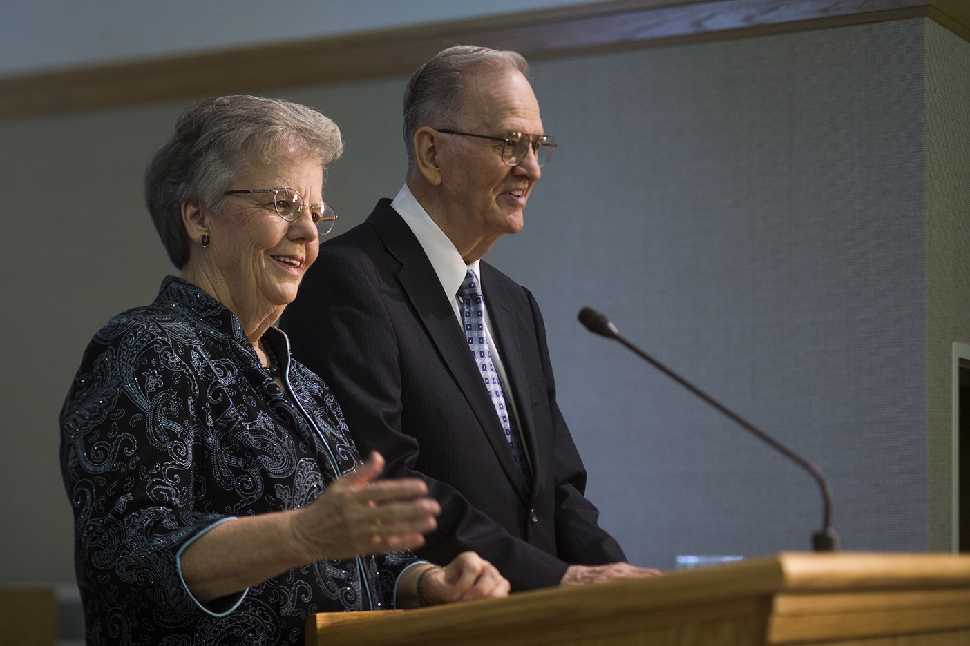 Janice Knapp Perry stands with her husband at a pulpit