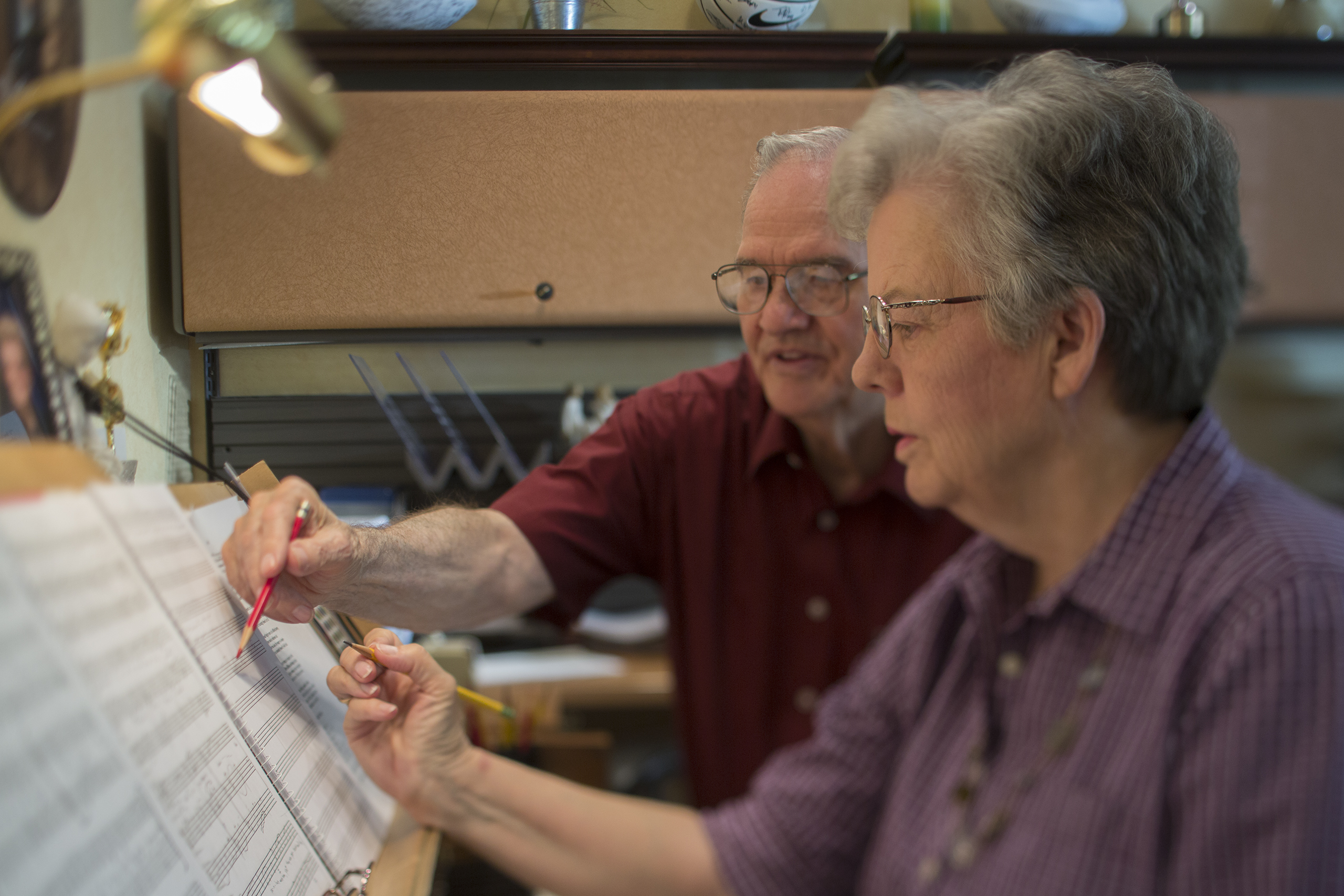 Janice Kapp Perry works on a song, writing on sheet music on the piano