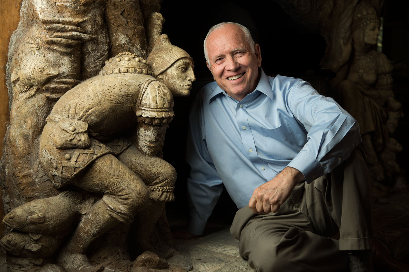 ames Christensen posing by a golden statue